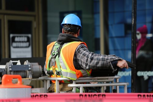 a construction worker on site with a danger sign surrounding him