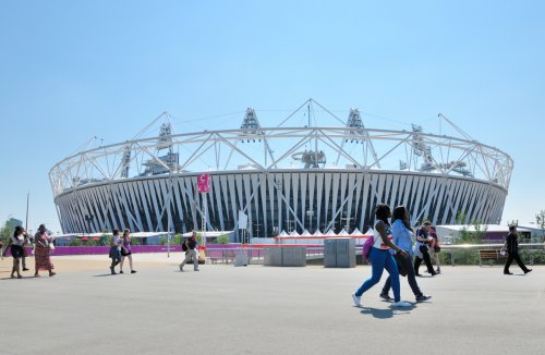 People Walking Past Olympic Stadium